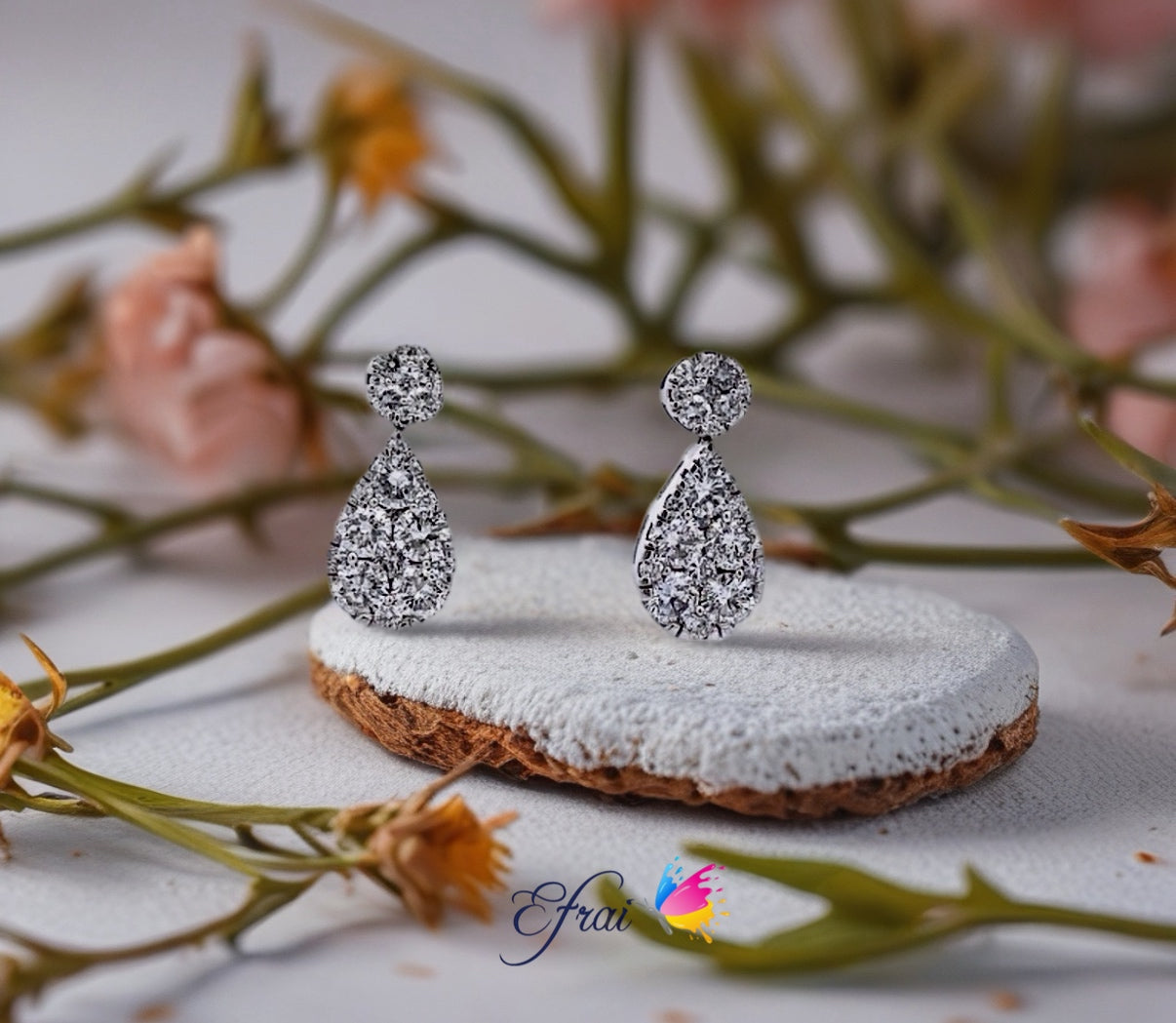 Round and pear drop diamonds earrings